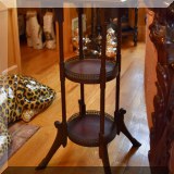 F28. Tiered plant stand with brass galleries.